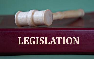 LEGISLATION - word on a burgundy folder on the background of a judge's gavel