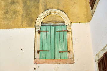 Green wooden door on an old house.