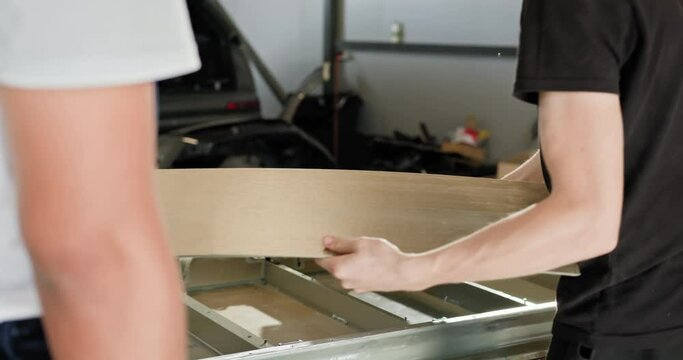 Technician Handling EV Car Battery Module in Workshop. A Technician Carefully Manages An EV Car Battery Module In A Workshop, Ensuring Optimal Performance. Auto Service, Electric Car Battery Handling.