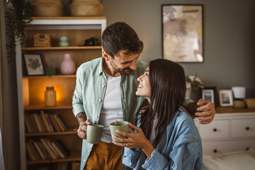 Boyfriend and girlfriend drink coffee and enjoy at home