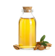 Bottle of almond oil, fresh nuts and green leaves isolated on white