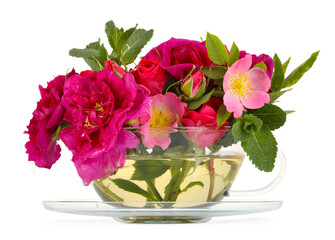 Aromatic herbal tea in glass cup with different flowers isolated on white