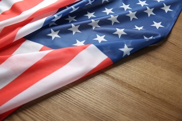 Flag of USA on wooden table, closeup. Space for text