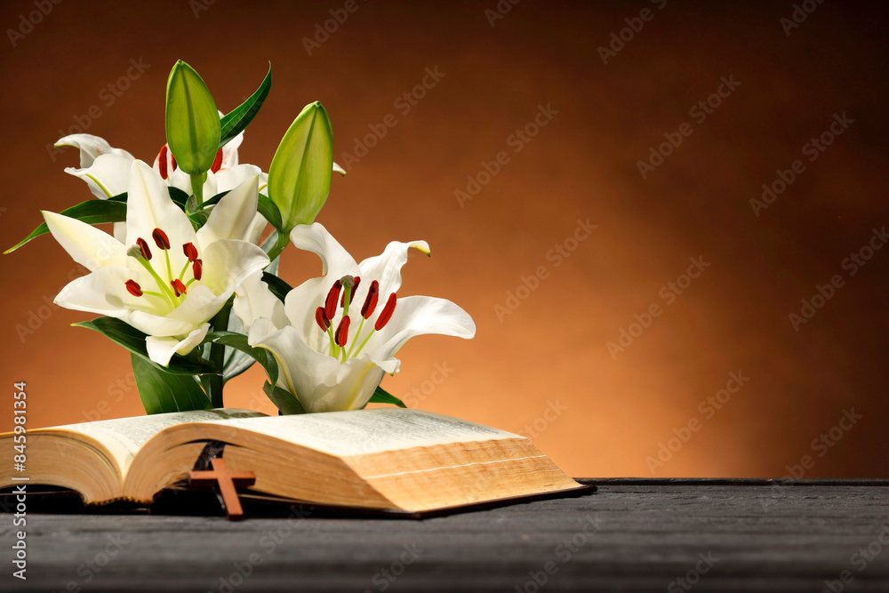 Wall mural bible, cross and lilies on gray table against brown background, space for text. religion of christia - Wall murals