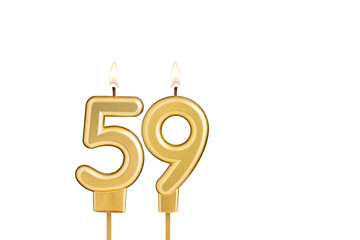 Golden number 59 birthday candle on white background