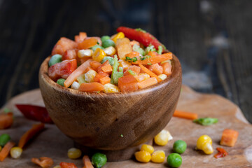 a mixture of quick-frozen corn, peas, peppers, and carrots
