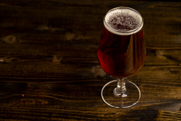 dark beer in a glass glass, fresh dark alcoholic beer