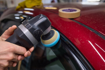 Car detailing enhances shine of vehicle with machine buffer for glossy finish