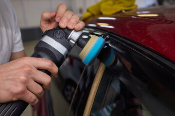 Car detailing enhances shine of vehicle with machine buffer for glossy finish