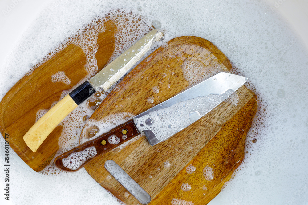 Wall mural wooden cutting board in foam of dishwashing liquid.