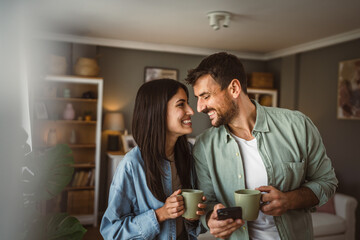 Couple use mobile phone for text message or browse internet at home