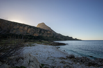 Nature Park of Monte Cofano during golden hour at sunset with coastline of the mediterranean sea, San Vito Lo Capo, Sicily, Italy