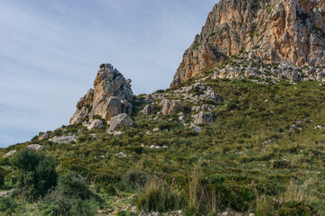 View at rocky landscape with green vegetation in Nature Park of Monte Cofano at mediterranean sea, San Vito Lo Capo, Sicily, Italy