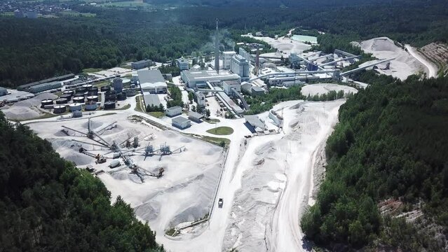 Aerial view of factory plant producing ceramic tiles from raw kaolin material. Industrial area in countryside from above. Kaznejov, Czech republic, European union.