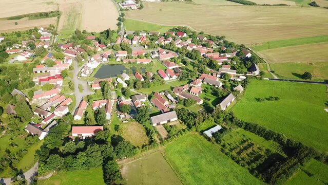 Aerial view of beautiful village in summer countryside. Circular shape traditional village Lipnice in Brdy, Czech republic, Europe. Drone camera flying over beautiful landscape.