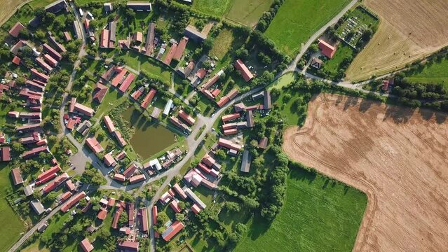 Top down view of beautiful village in summer countryside. Circular shape traditional village Lipnice in Brdy, Czech republic, Europe. Drone camera flying over beautiful landscape.