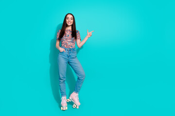 Full length photo of girlish pretty lady dressed retro top enjoy roller skating showing finger...