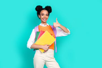 Portrait of nice young girl book thumb up wear vest isolated on turquoise color background