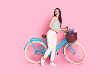 Photo of charming cheerful cute woman wear stylish clothes look empty space isolated on pink color background