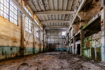 Fototapeta premium Large abandoned industrial hall interior