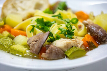 Luxurious table setting with white plates, crystal glasses and fine cutlery. Soup