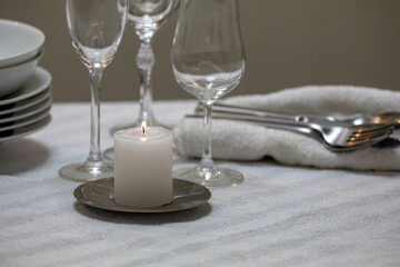 Luxurious table setting with white plates, crystal glasses and fine cutlery