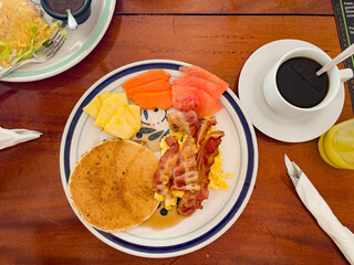 Pancakes Eggs and Bacon, Big Breakfast at a Cafe, Coffee,  Fruits, water melon, Cantaloupe, Watermelon, Pineapple, Hotel Breakfast, Resort, Continental Breakfast, Food photography, Big plate