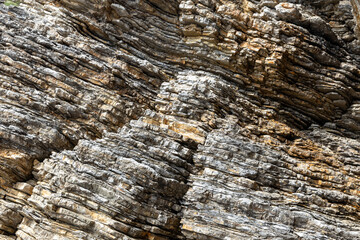 Textured Rocky Cliff. Close-up of a textured rocky cliff showing the layers of rock formations.
