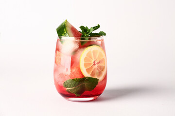 Glass of fresh watermelon lemonade with mint on white background
