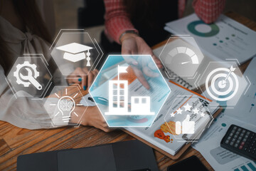 Apprenticeship concept, Business team analyzing income charts and graphs on desk with school, studies, profesion, skills, performance, motivation and goals icon on virtual screen.