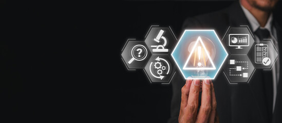 Incident management concept, Businessman hand holding lightbulb with incident, analysis, restore, report, identify and investigation icon on virtual screen.