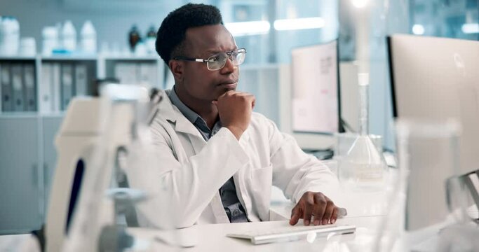 Science, thinking and black man in laboratory with computer for results, test and medical study. Technology, scientist or lab technician reading web review, report or data on pharmaceutical research