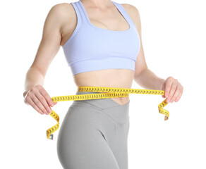 Woman with measuring tape showing her slim body against white background, closeup