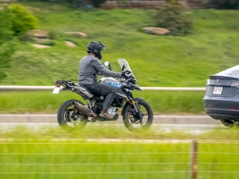 Calgary, Alberta, Canada. Jun 9, 2024. A person riding a motorcycle BMW Motorrad display featuring BMW G 310 GS and BMW G310R motorcycles.