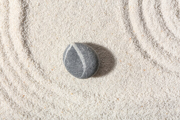 Stone on sand with lines in Japanese rock garden.  Zen concept