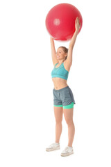 Sporty young woman with fitball on white background