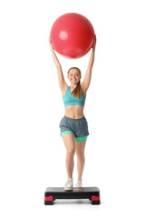 Sporty young woman with fitball and stepper training on white background