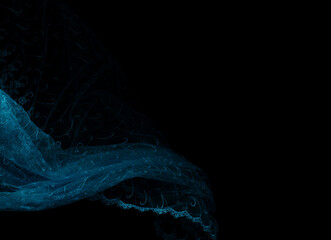 Blue lace fabric flying in curve shape, Piece of textile blue lace fabric throw fall in air. Black background isolated, dark shading environment