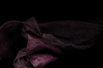 Purple Silver lace fabric flying in curve shape, Piece of textile purple silver lace fabric throw fall in air. Black background isolated, dark shading environment