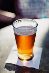 Ice cold pint of beer on cafe table in Los angeles, California, USA.