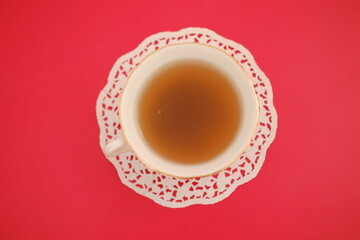 A cup of tea on a red background