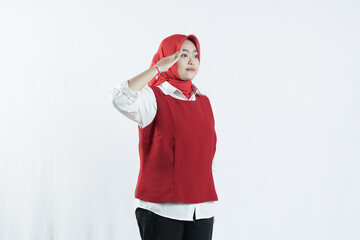 Beautiful Asian hijab woman  giving salute celebrate Indonesian independence day on August 17 isolated over white background