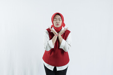 Asian hijab woman in looks happy in Indonesian independence day outfit. the woman raised one hand and showed five fingers as a sign of enthusiasm