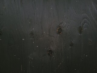 Black wooden background. Abstract minimalistic image of a wooden surface.