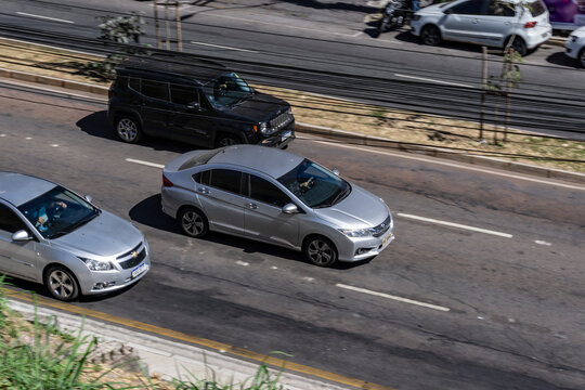 Panning shot of a silver Honda Civic G9, Japanese sedan in city street - High Resolution Image