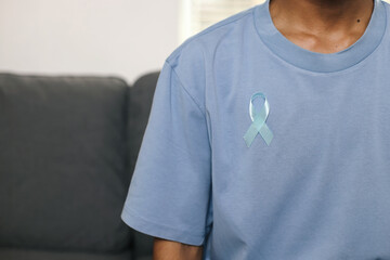 Man With Light Blue Ribbon. Prostate Cancer Awareness Concept