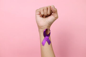 International Epilepsy Day. Hand Wearing Purple Ribbon On Fist Hand. Alzheimer's disease,...