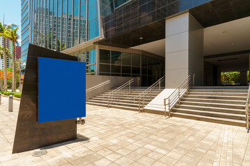 Fototapeta premium Office buidling sign and steps at entrance. Blue advertising space on sign