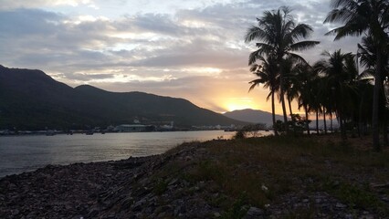 Sunset Over Palm Trees and Coastal Mountains