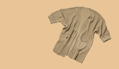 Cozy Beige Knit Cardigan on Neutral Background - Fall/Winter Fashion Trend